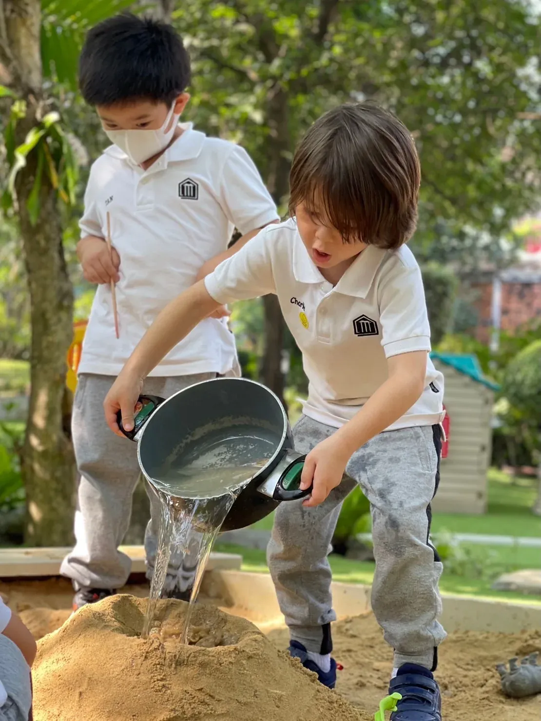 Children playing together in the outdoor creative play space