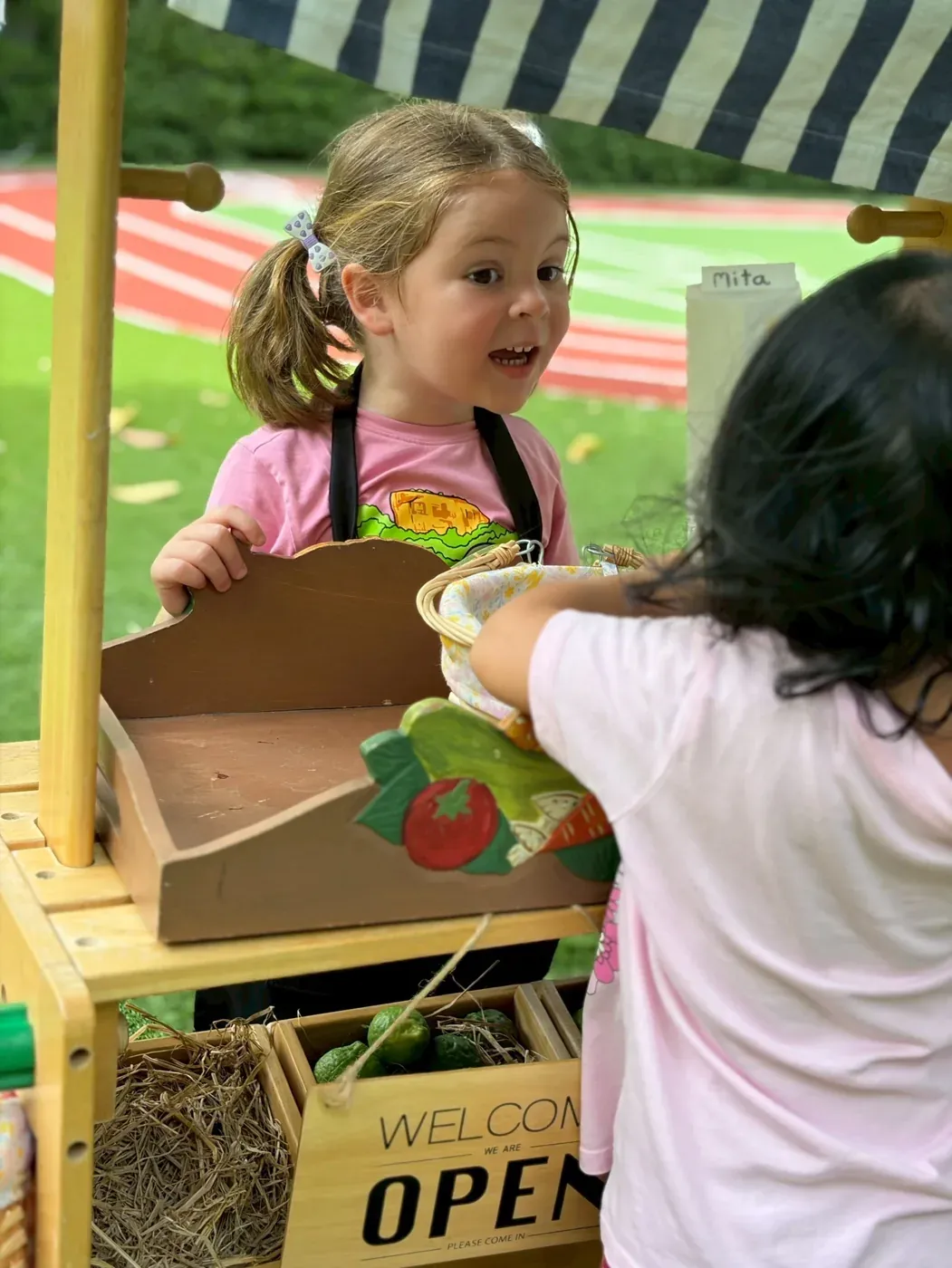 Children running their stall at the KIMS Market, open for business