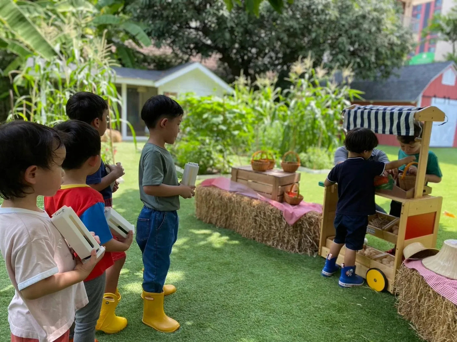 Children queueing at the market cart with their boxes, waiting their turn to buy