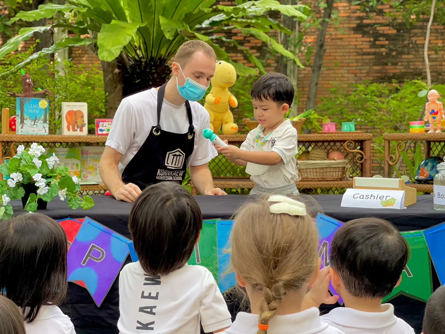 A teacher and children sharing a Thai and English lesson together